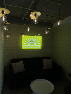 A friendly Sunshine Decorator team member smiling while discussing renovation plans with a client in a bright, cozy living room.