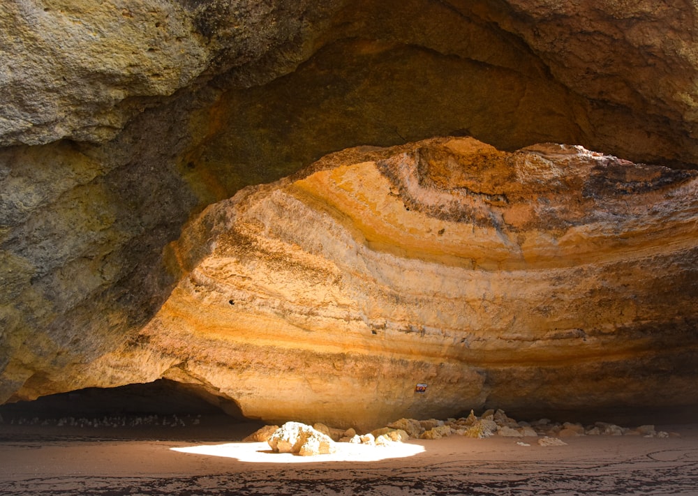 a large rock formation in the middle of a beach