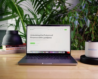 a laptop computer sitting on top of a wooden table