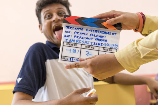 Close-up of a team member recording a funny TikTok skit with props.