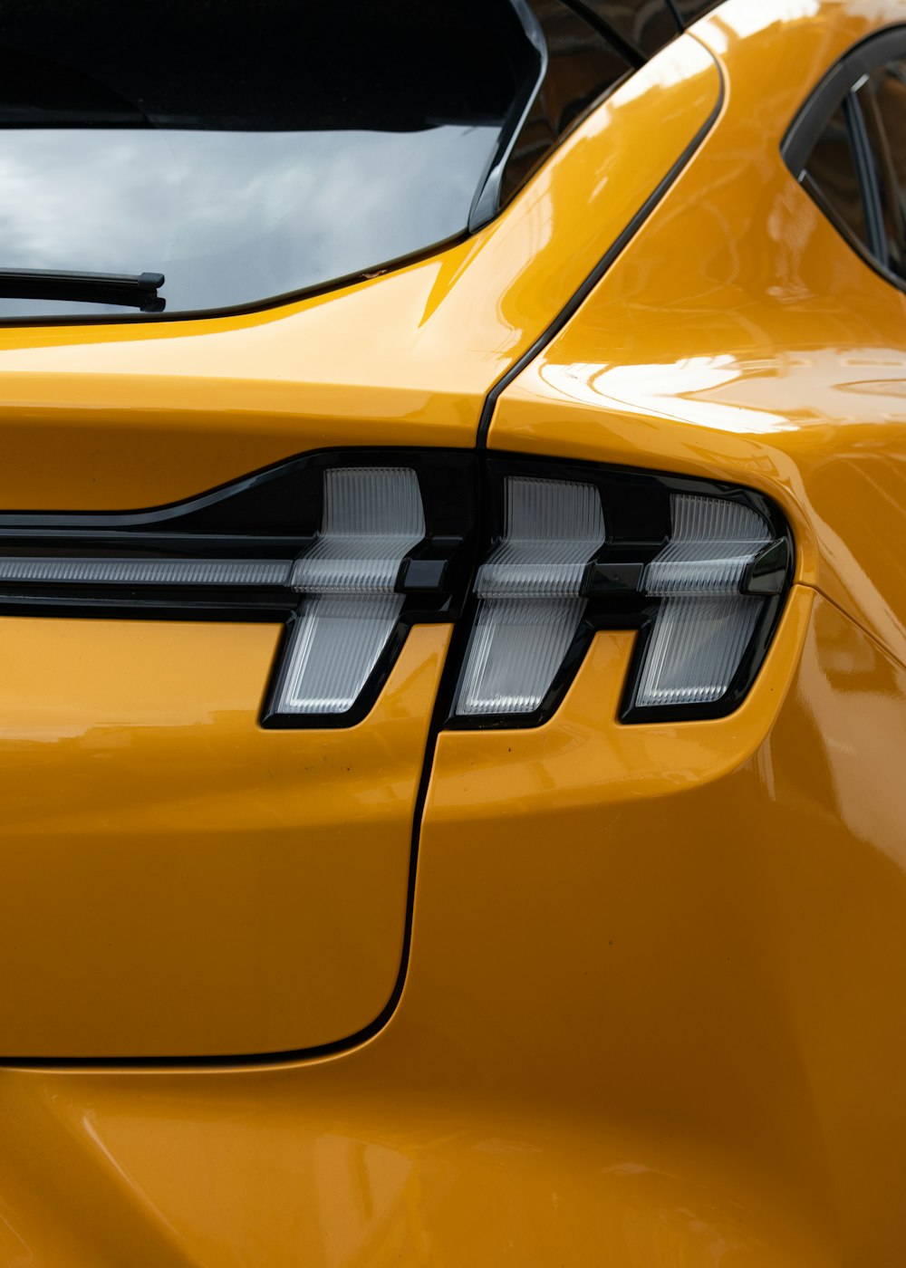 the front end of a yellow sports car