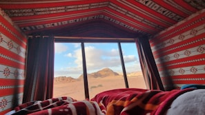 Traditional Berber tent nestled among rocky desert hills