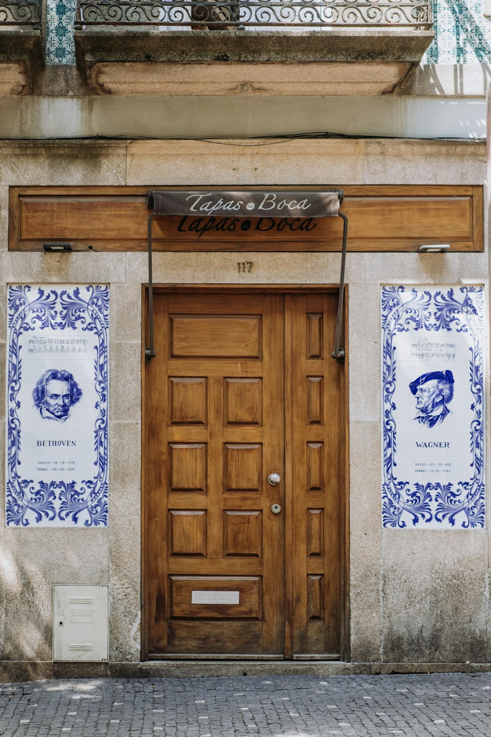 a building with two doors and a sign on the front of it