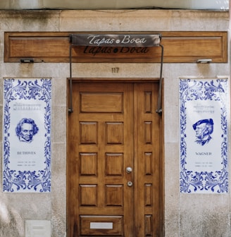 a building with two doors and a sign on the front of it