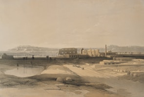 A serene desert landscape with ancient architectural structures in the background. In the foreground, a small pond or waterhole reflects the sky. Sparse vegetation, including a few palm trees, is scattered around. A group of people is seen moving along a path leading towards the buildings.