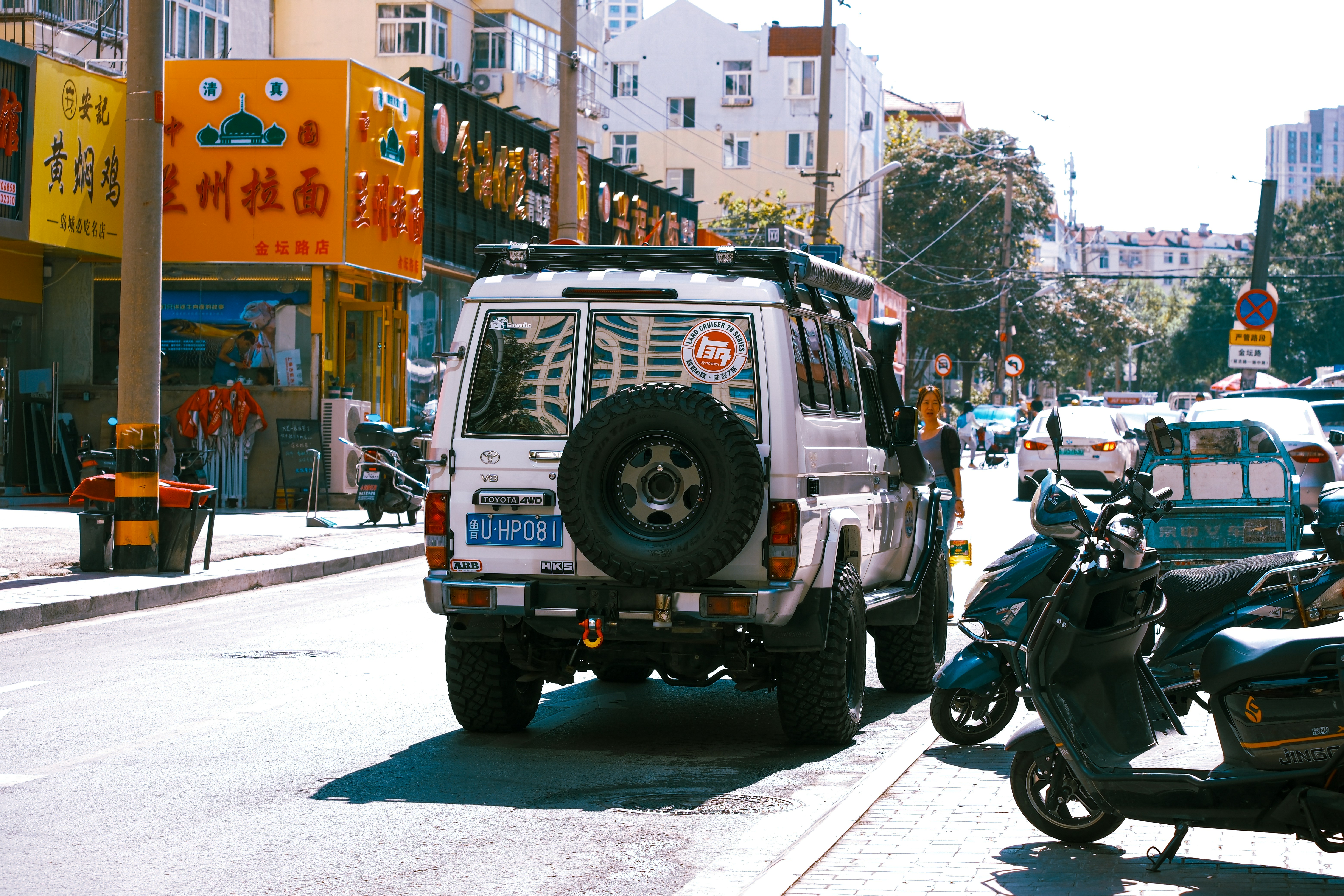 A white jeep parked on the side of a street photo – Free 青岛市 Image on ...