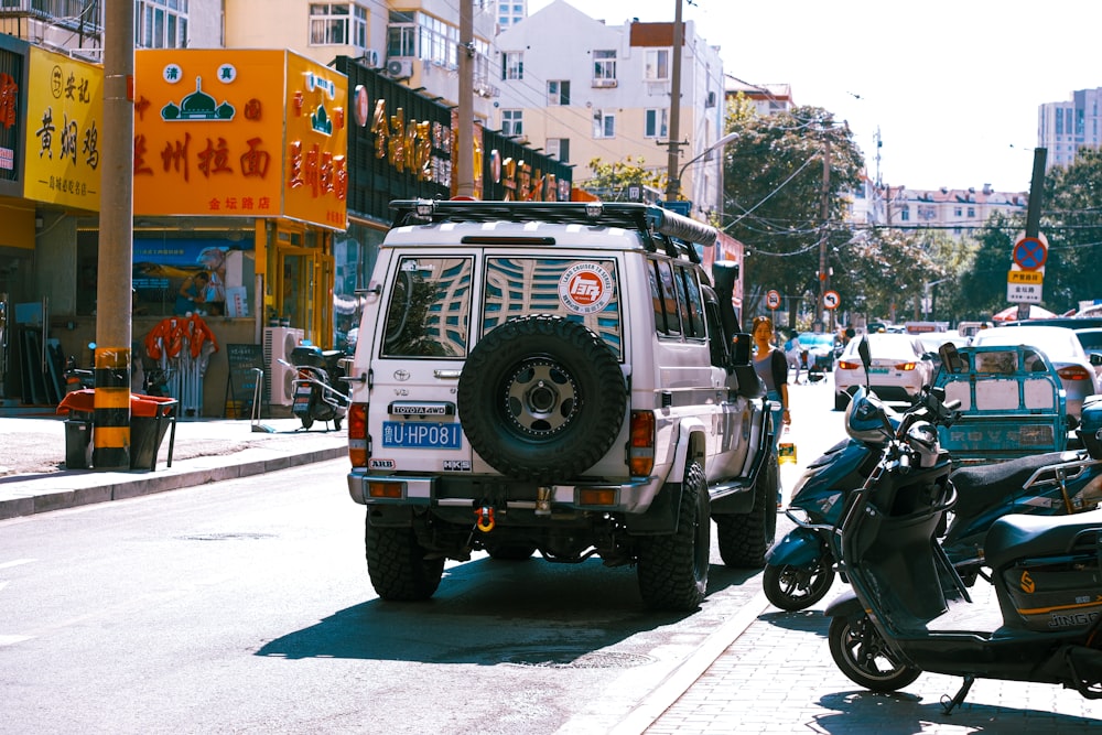 a white jeep parked on the side of a street