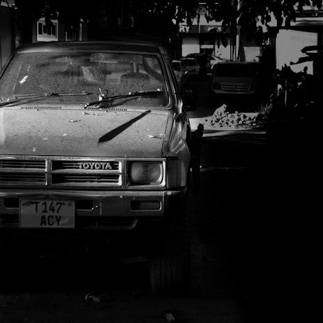 a black and white photo of a car parked in a garage