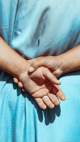 Side view of someone standing with perfect posture, the wearable subtly visible beneath their shirt.