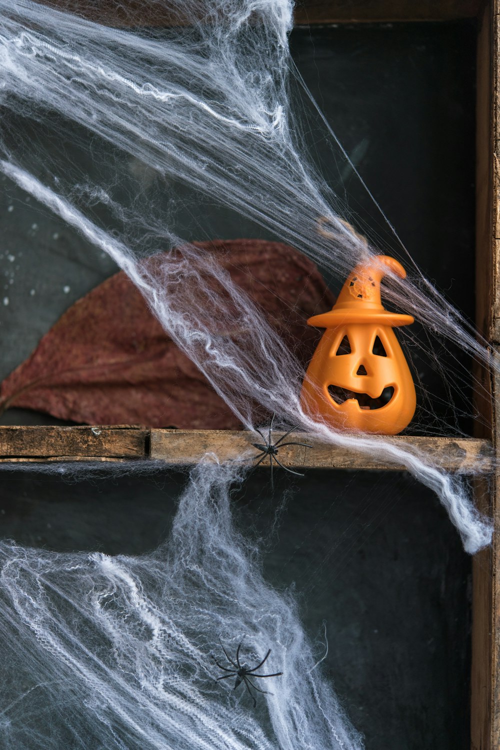 a halloween pumpkin sitting on top of a shelf