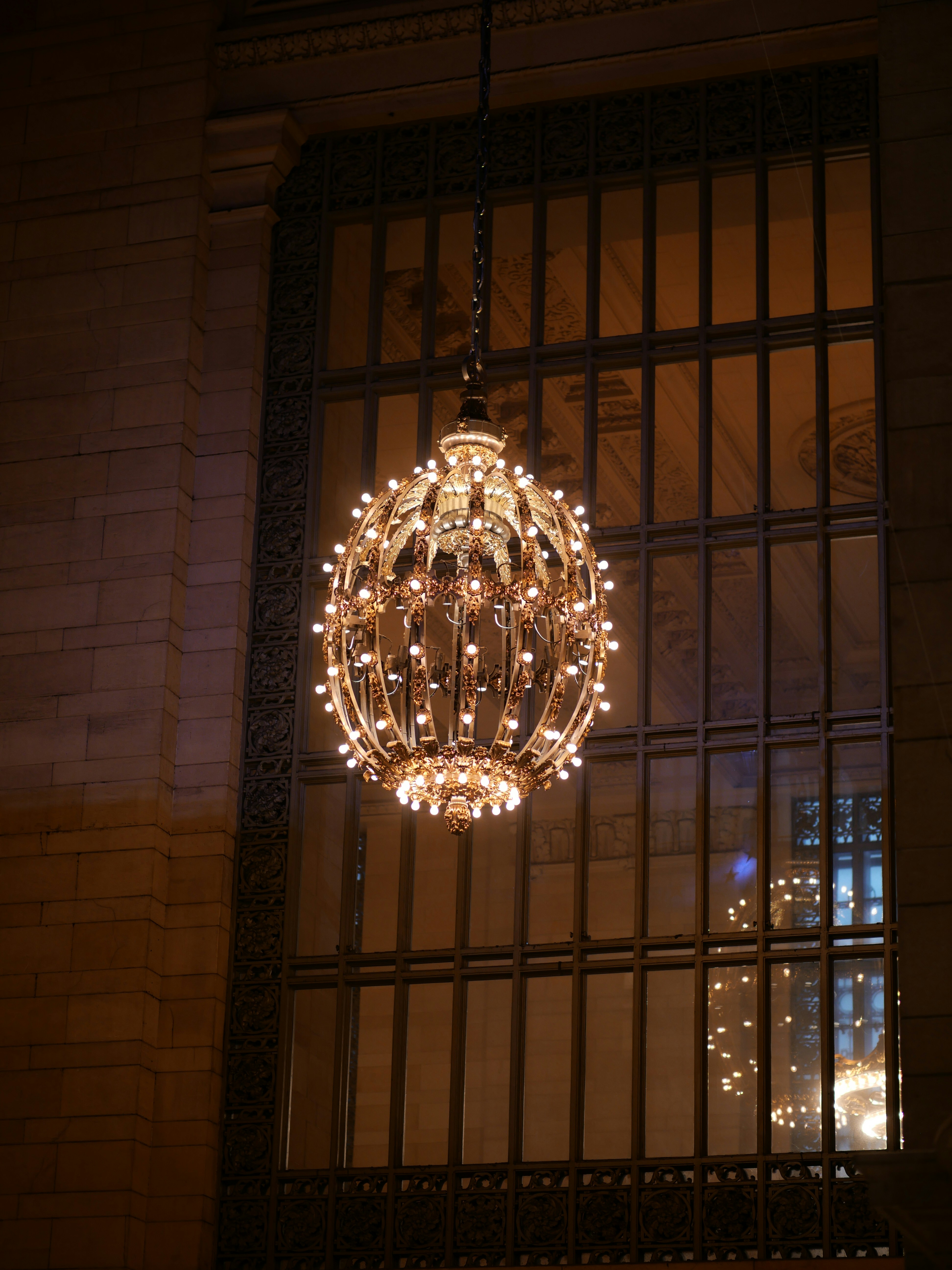 a chandelier hanging from the side of a building