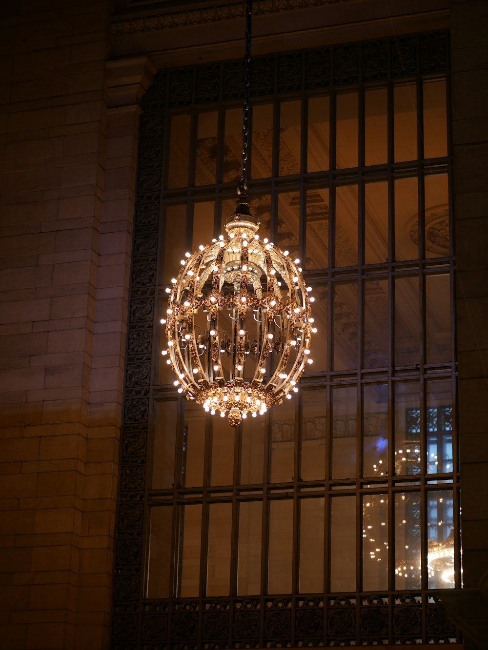 a chandelier hanging from the side of a building