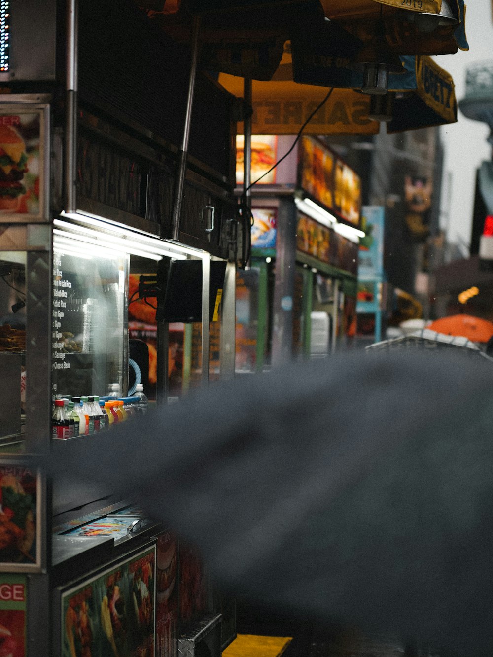 a person walking down a street holding an umbrella