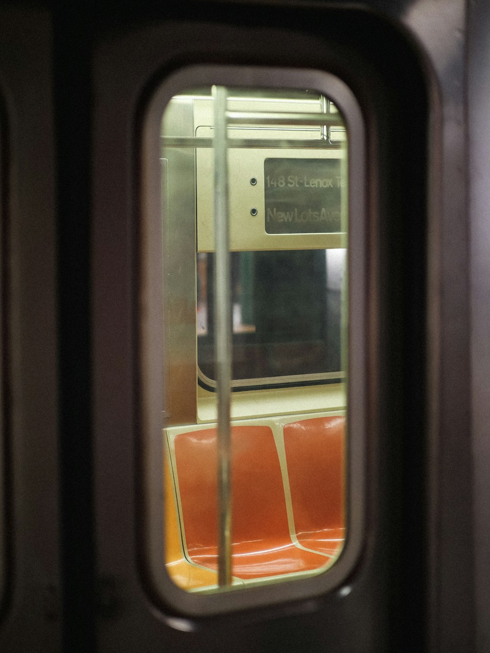 a view of the inside of a subway car through a window