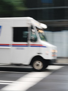 a delivery truck driving down a city street