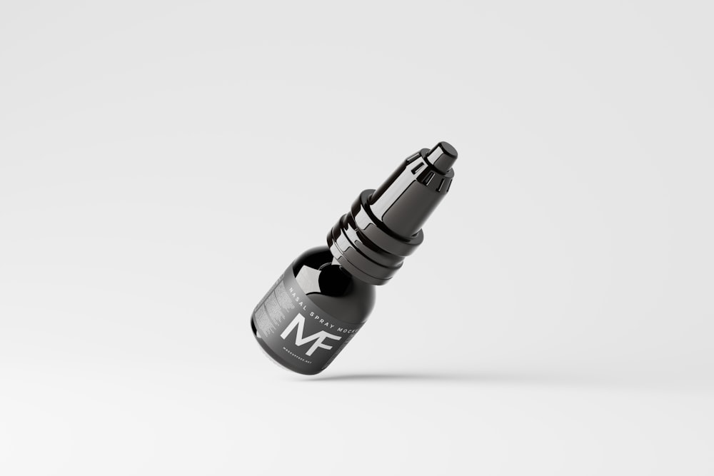 a black and white photo of a bottle of ink