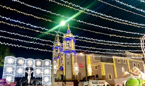 The church choir singing passionately during a special celebration, bathed in gentle blue and gold lighting.