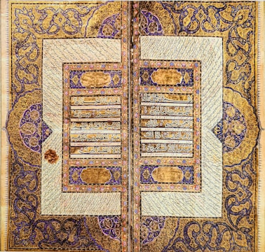 Close-up of intricate Mughal calligraphy on ancient manuscripts.