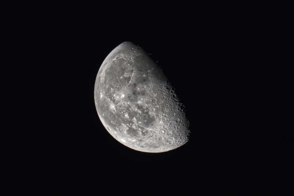 a close up of a half moon in the dark sky