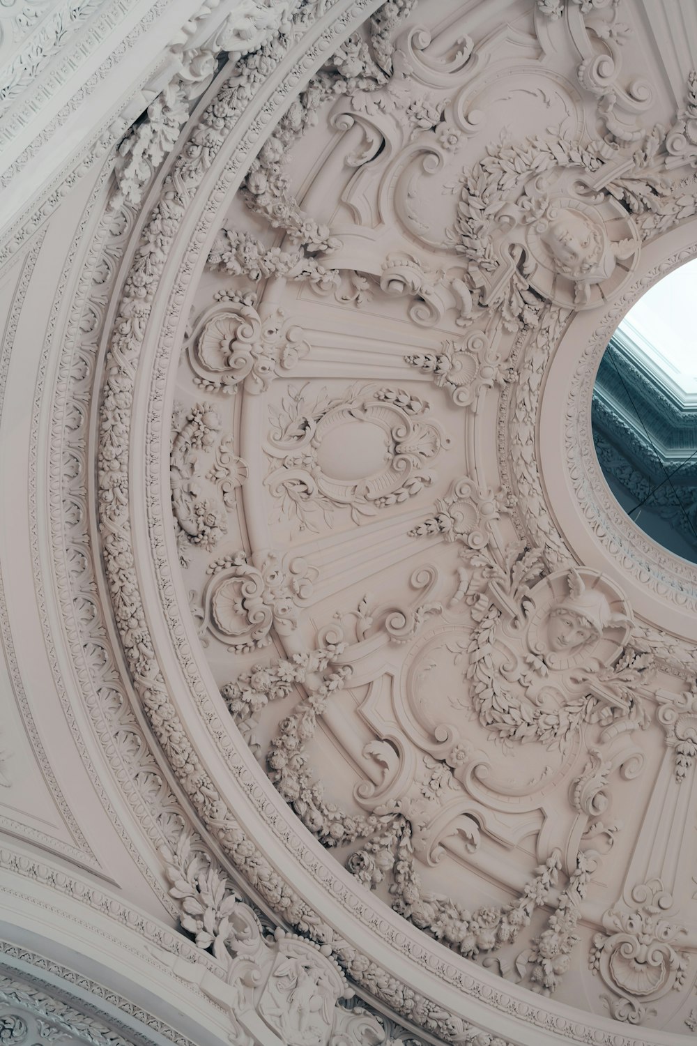 the ceiling of a building with a circular window