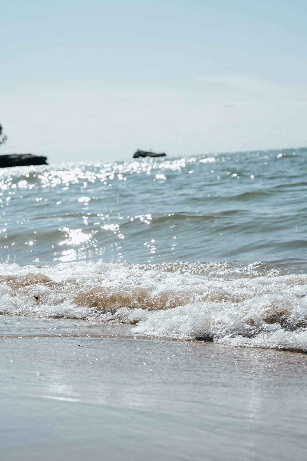 a beach with waves coming in to shore