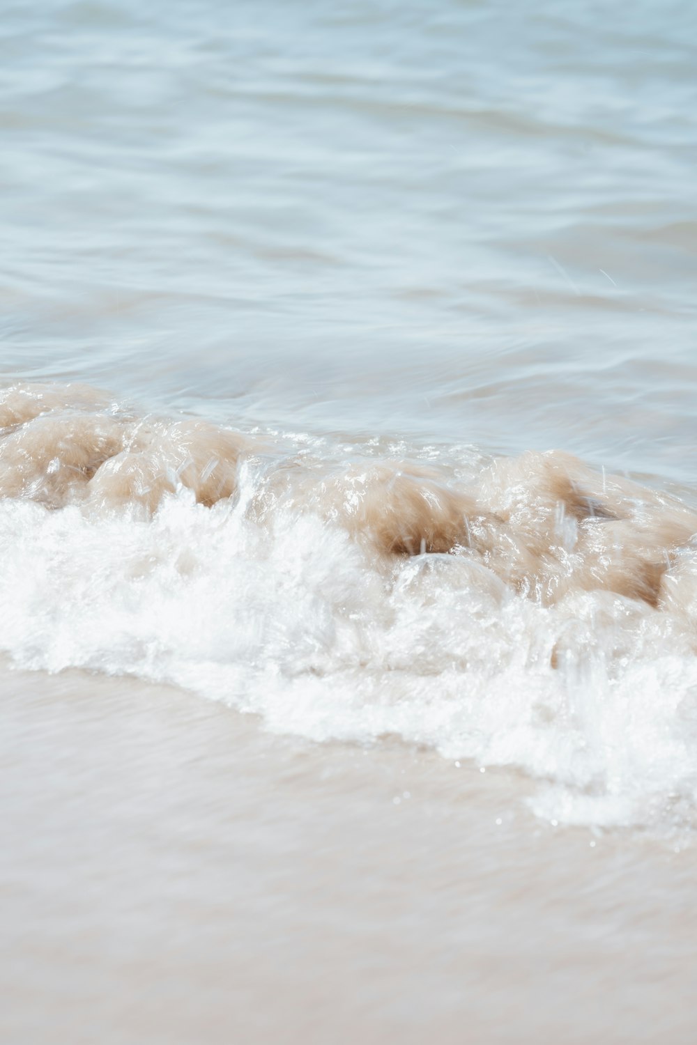 a person laying on a surfboard in the water