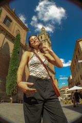 A joyful quinceañera posing in front of the Santuario de las Lajas at sunset.