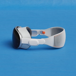 a pair of google glasses on a blue surface