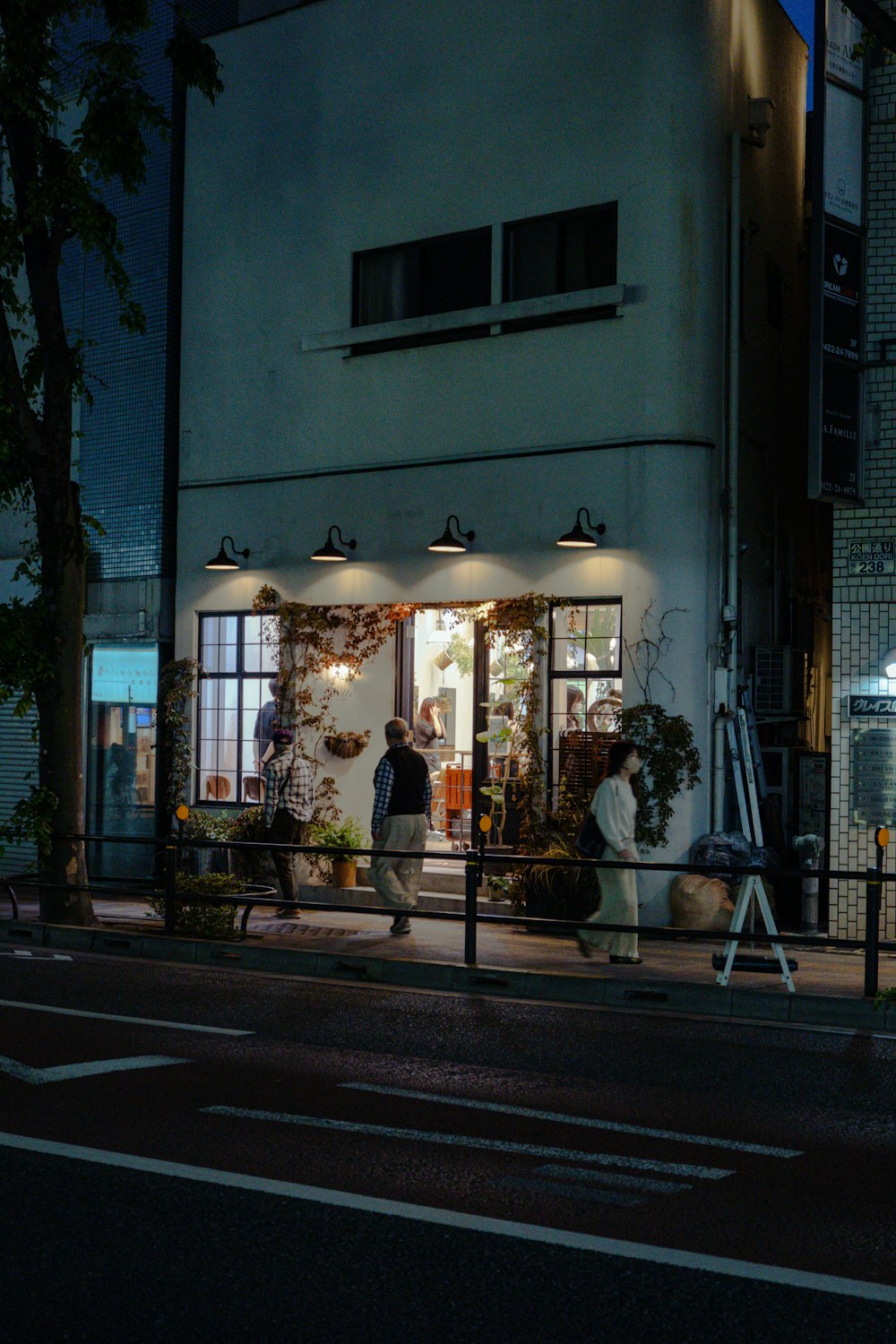 a man walking past a store front at night