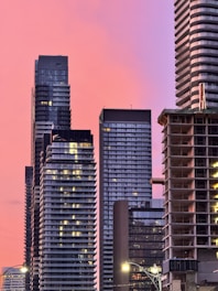 Modern high-rise buildings representing real estate development at sunset.