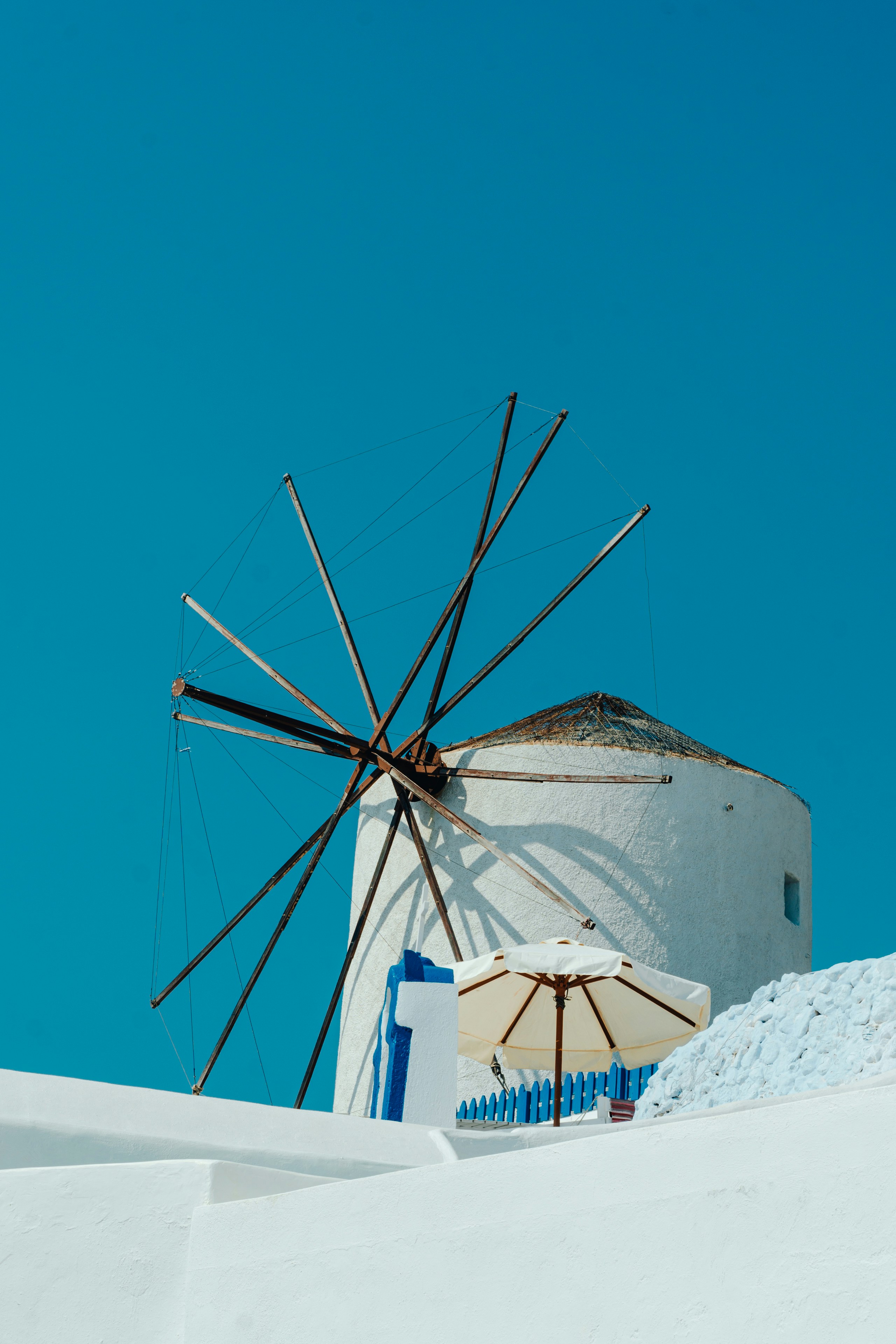 a large white windmill sitting on top of a snow covered hill