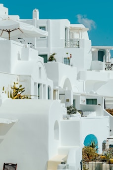 a white building with blue doors and windows