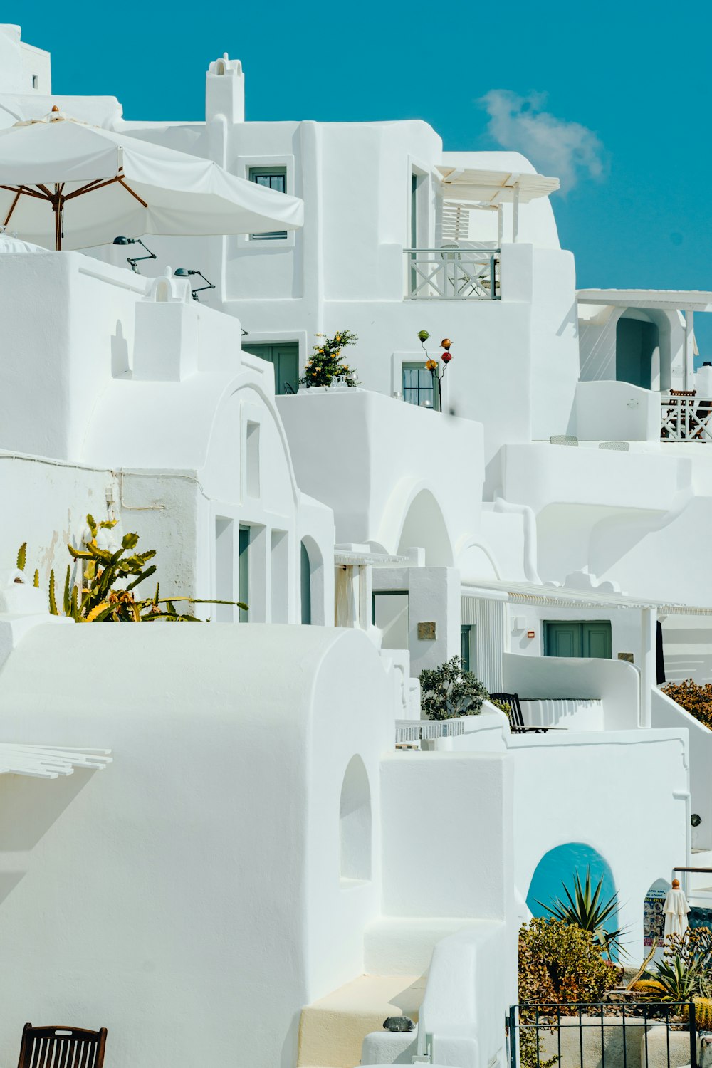 a white building with blue doors and windows