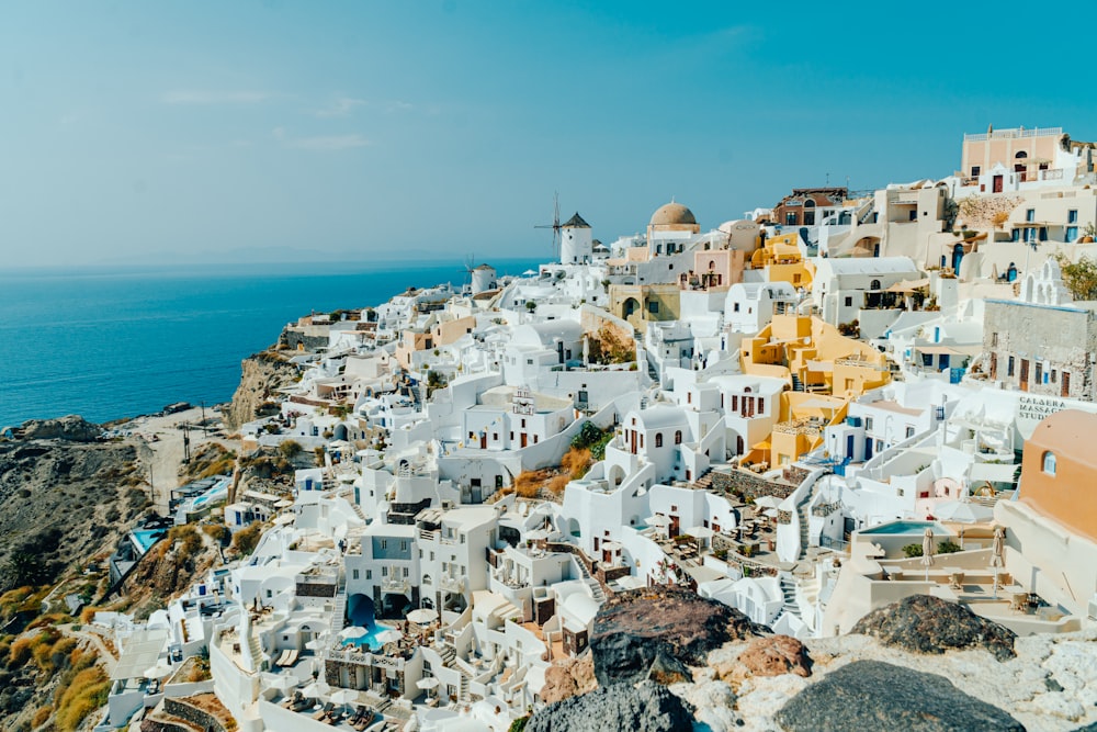 an aerial view of a village on a cliff overlooking the ocean