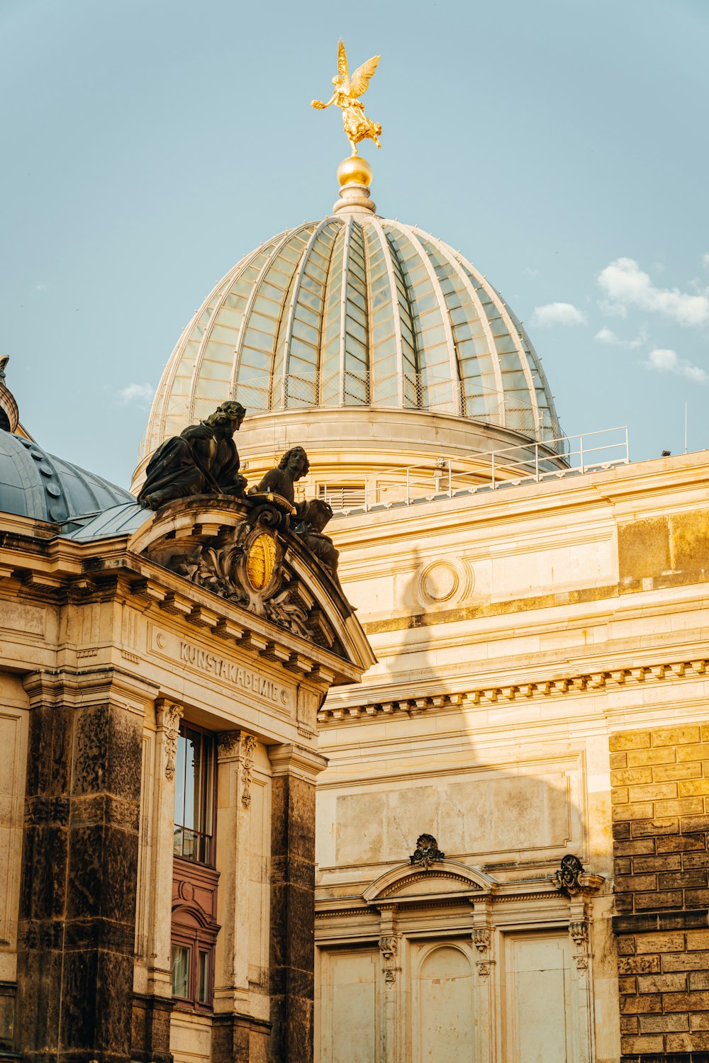 a building with a dome and a statue on top of it