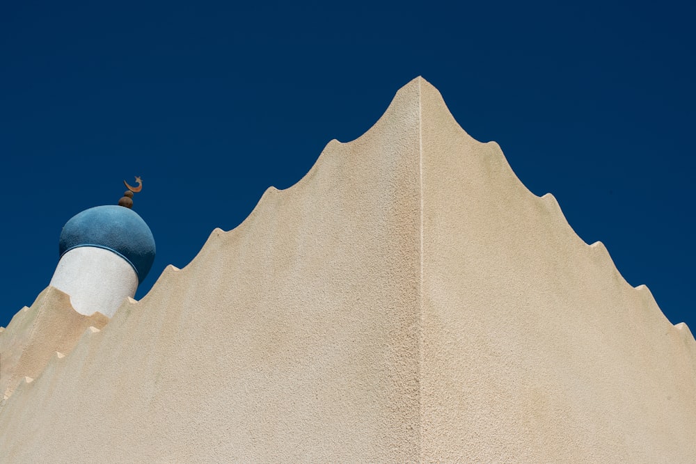 a tall white building with a blue dome on top