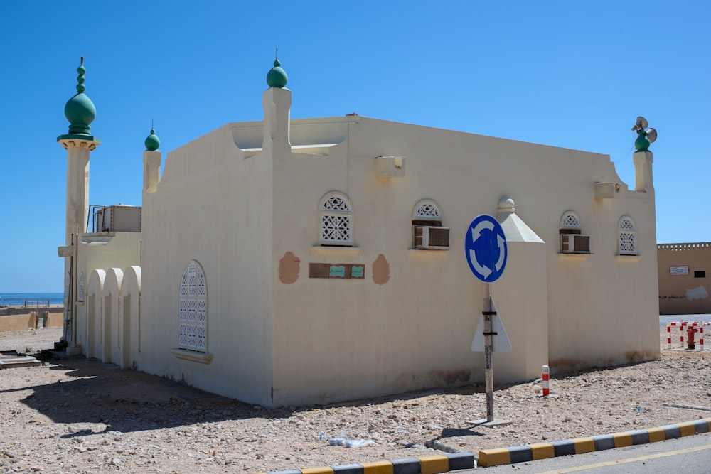 a white building with a blue sign in front of it