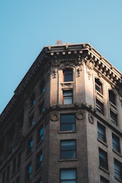 Wide shot of a restored building facade gleaming under sunlight after rehabilitation.
