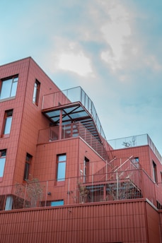 a red building with a staircase going up the side of it