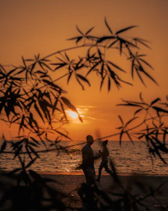 A romantic couple enjoying a sunset beach walk in Bali.