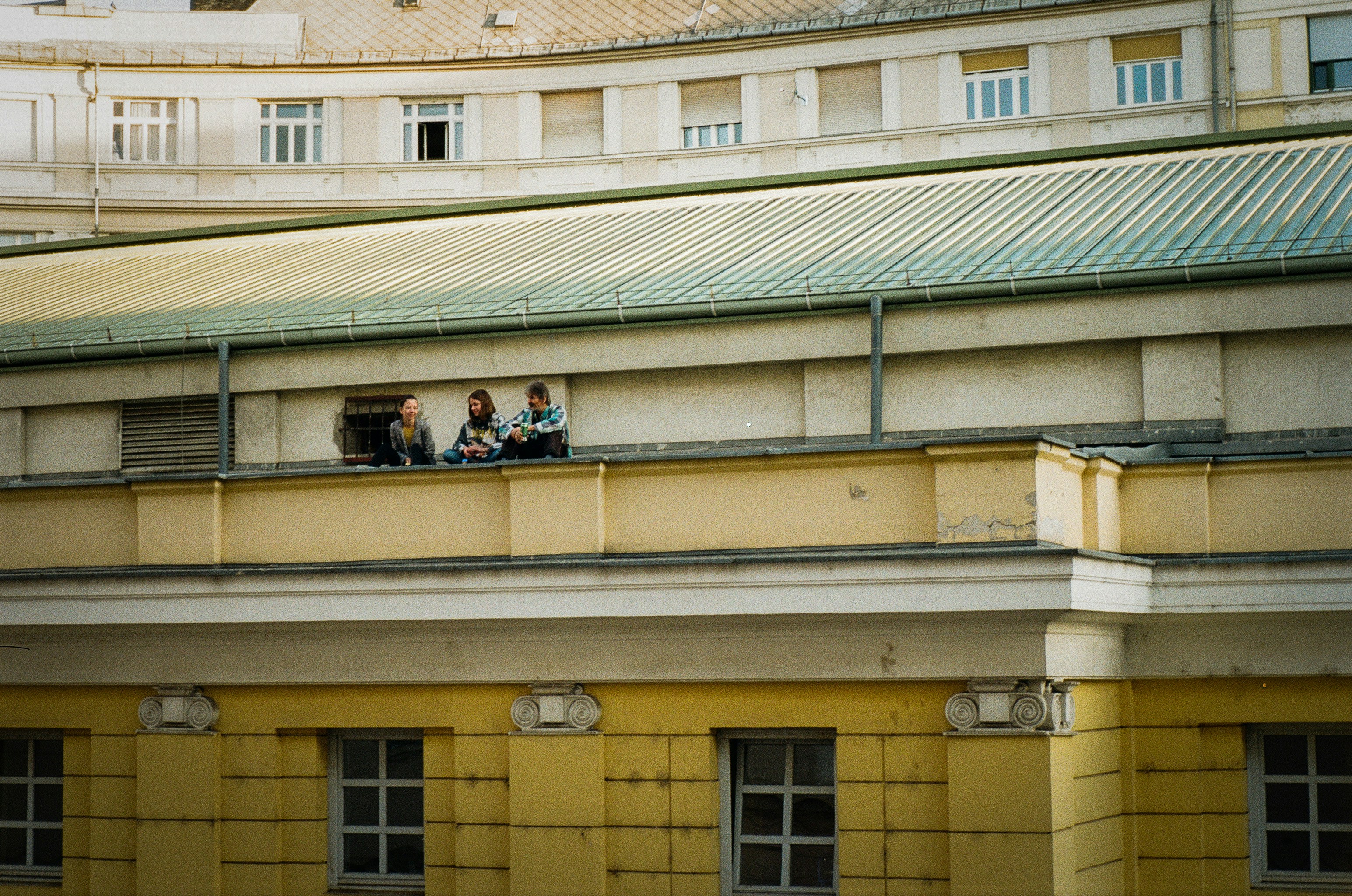 residents relaxing on a green rooftop deck with city views - eco friendly apartments chicago