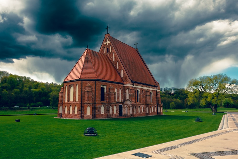 a large church with a steeple on a cloudy day