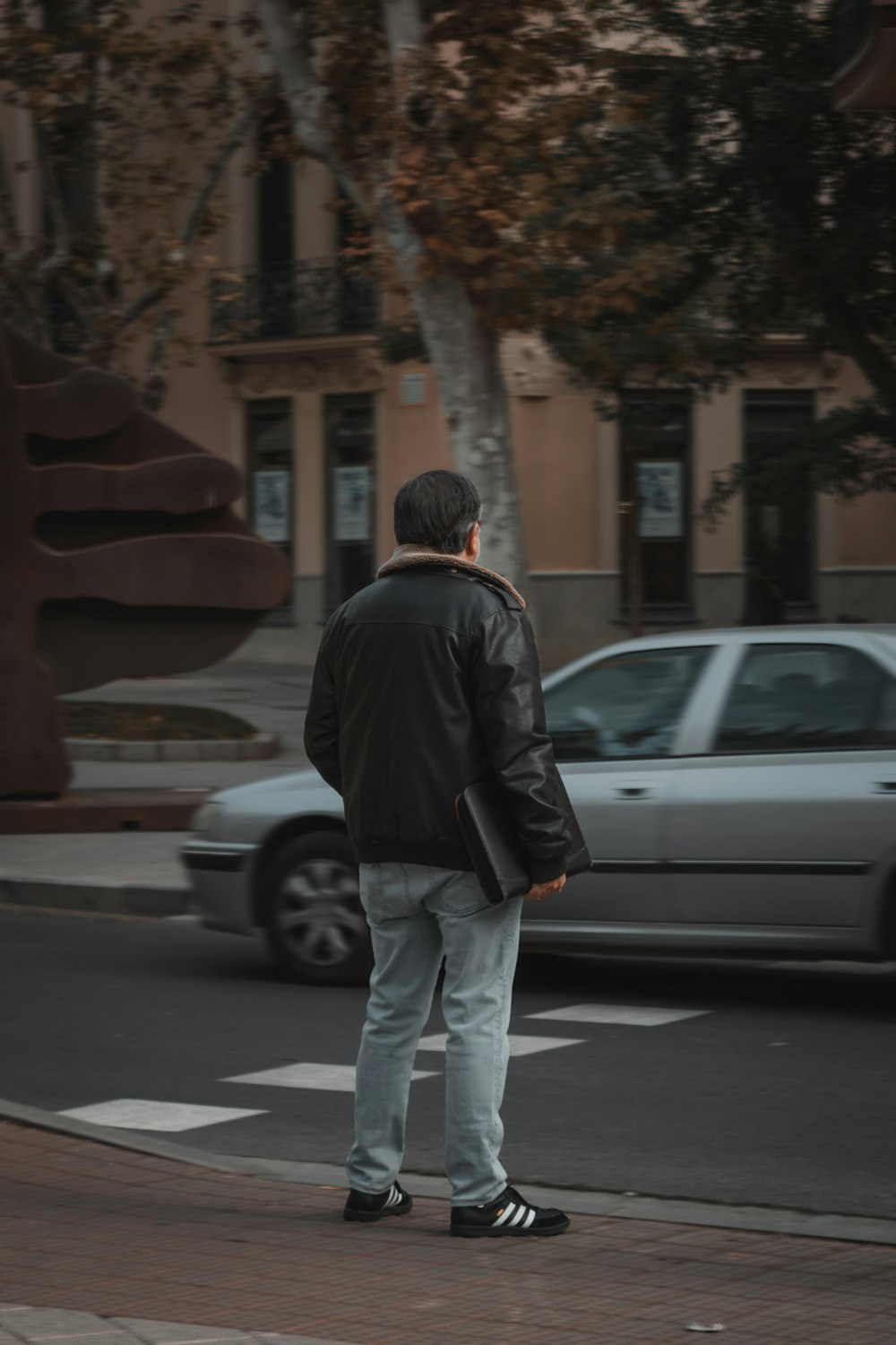 a man standing on the side of a road