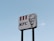 A tall roadside sign displays the KFC logo, featuring the company's name and a graphical portrait, set against a clear blue sky.