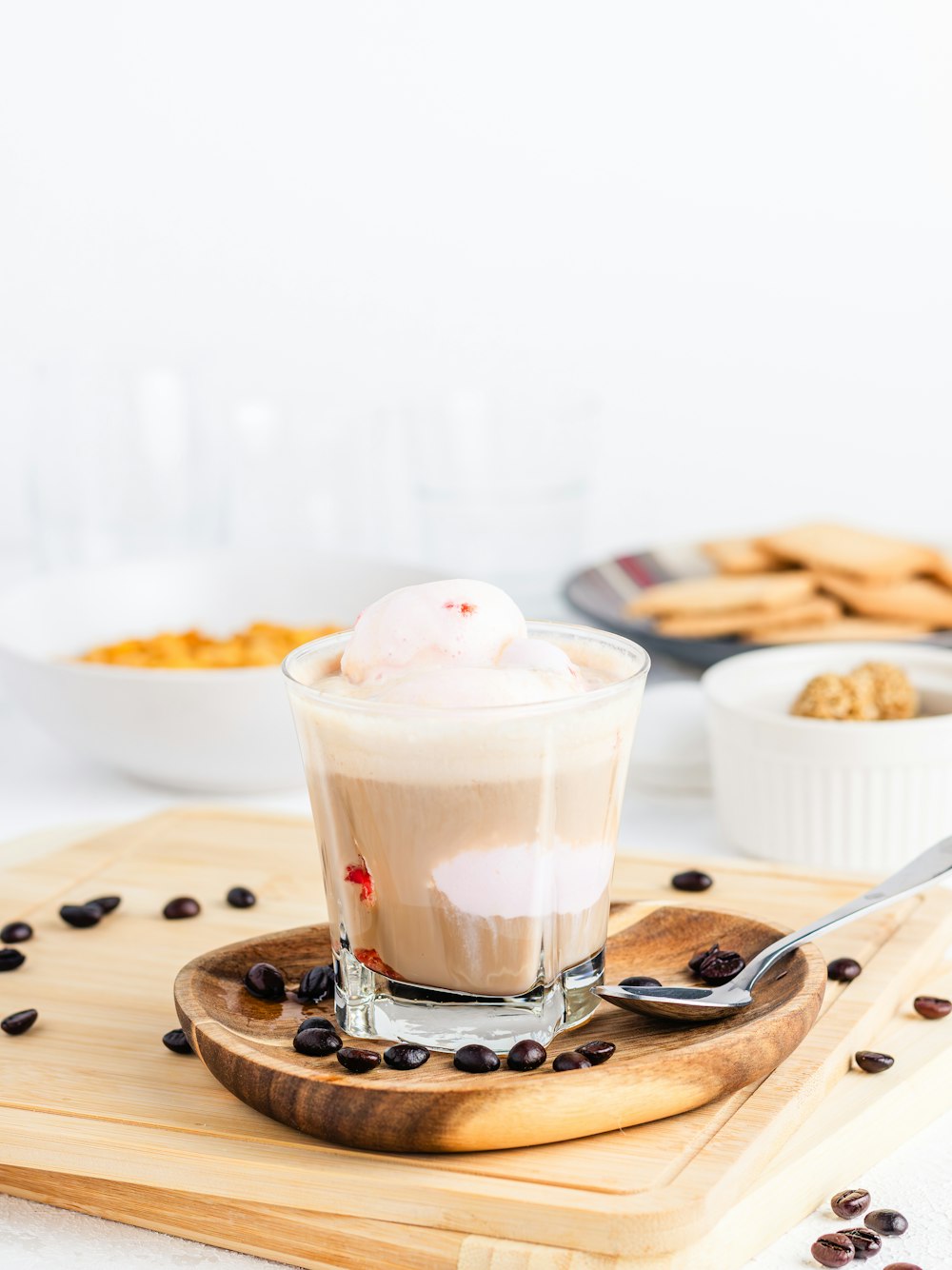 a cup of ice cream sitting on top of a wooden tray