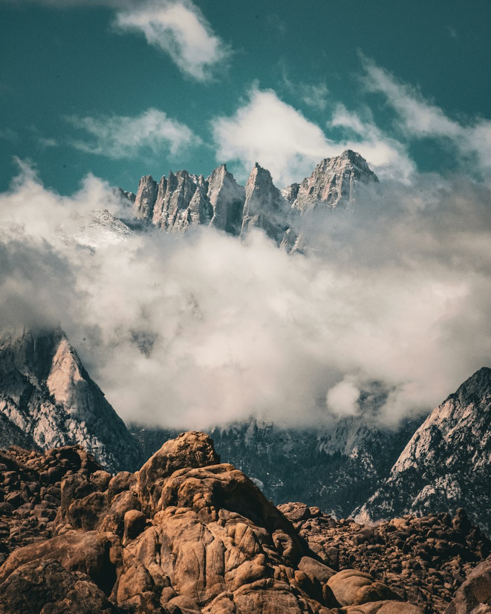 a mountain range covered in clouds and rocks