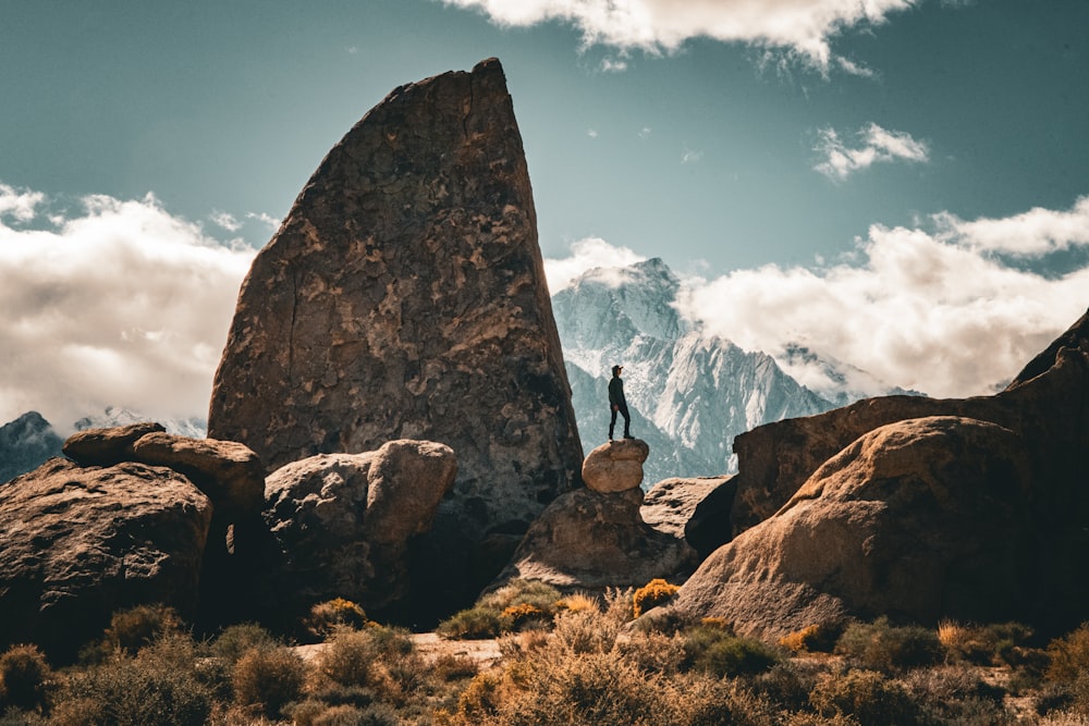 a man standing on top of a rock formation
