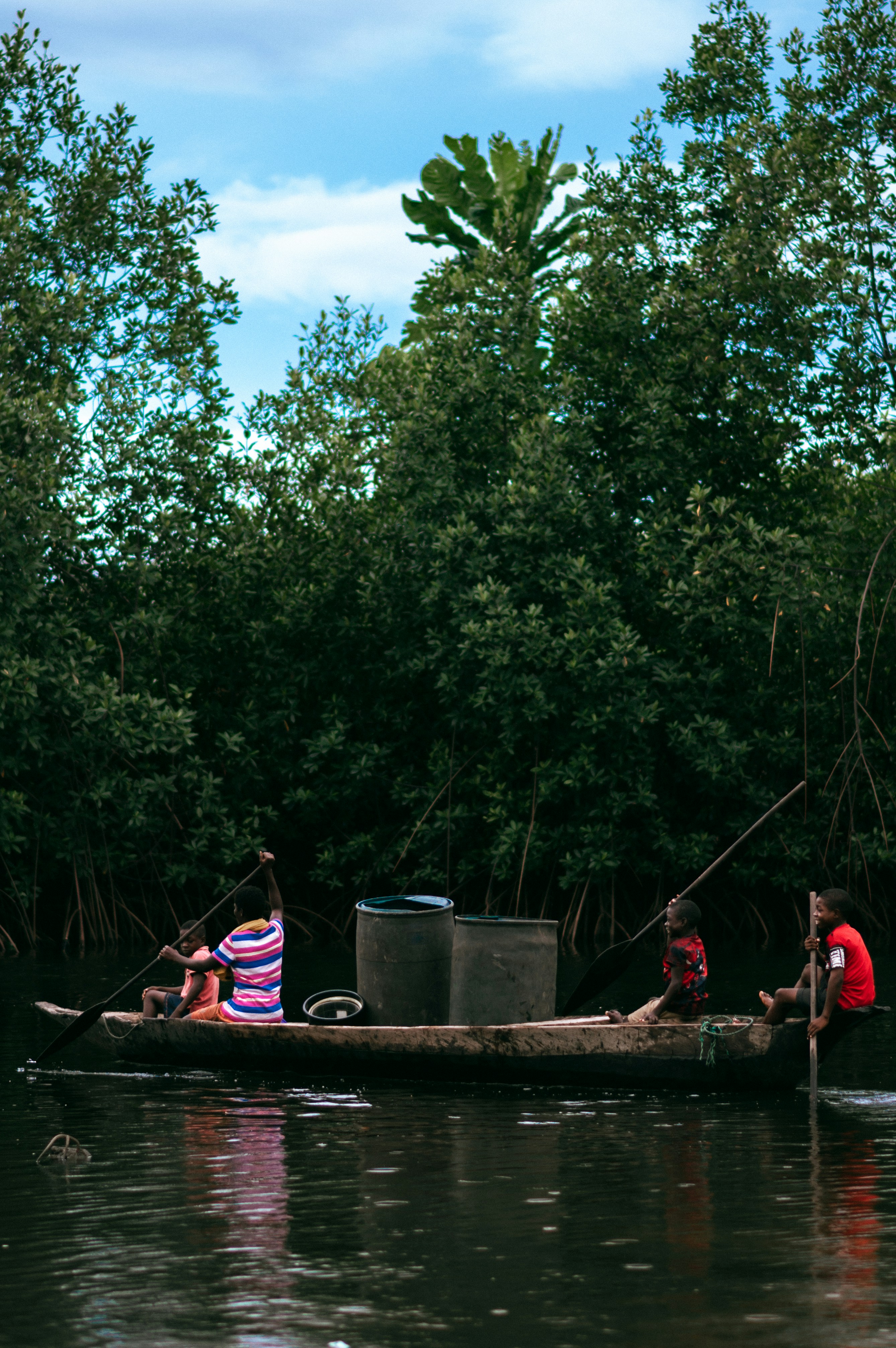 a group of people on a small boat in the water