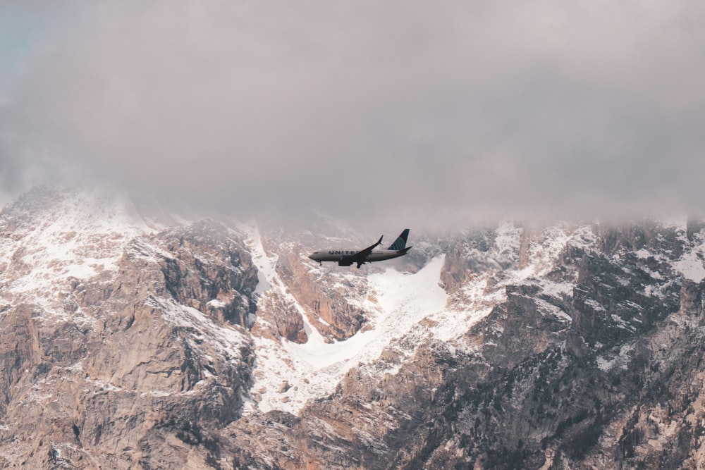 an airplane is flying over a mountain range