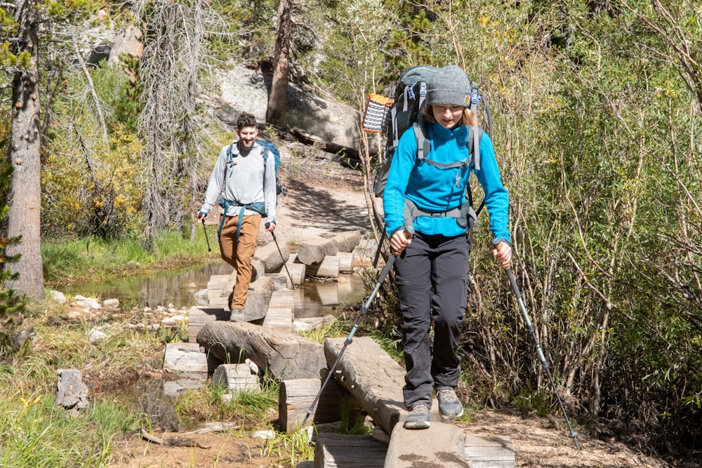 a couple of people that are walking across a bridge